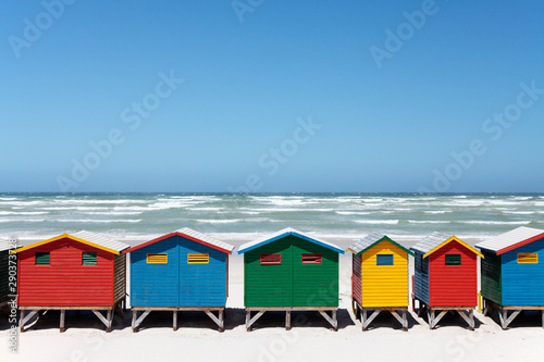 Colorful Beach Huts on Beach © neilovery