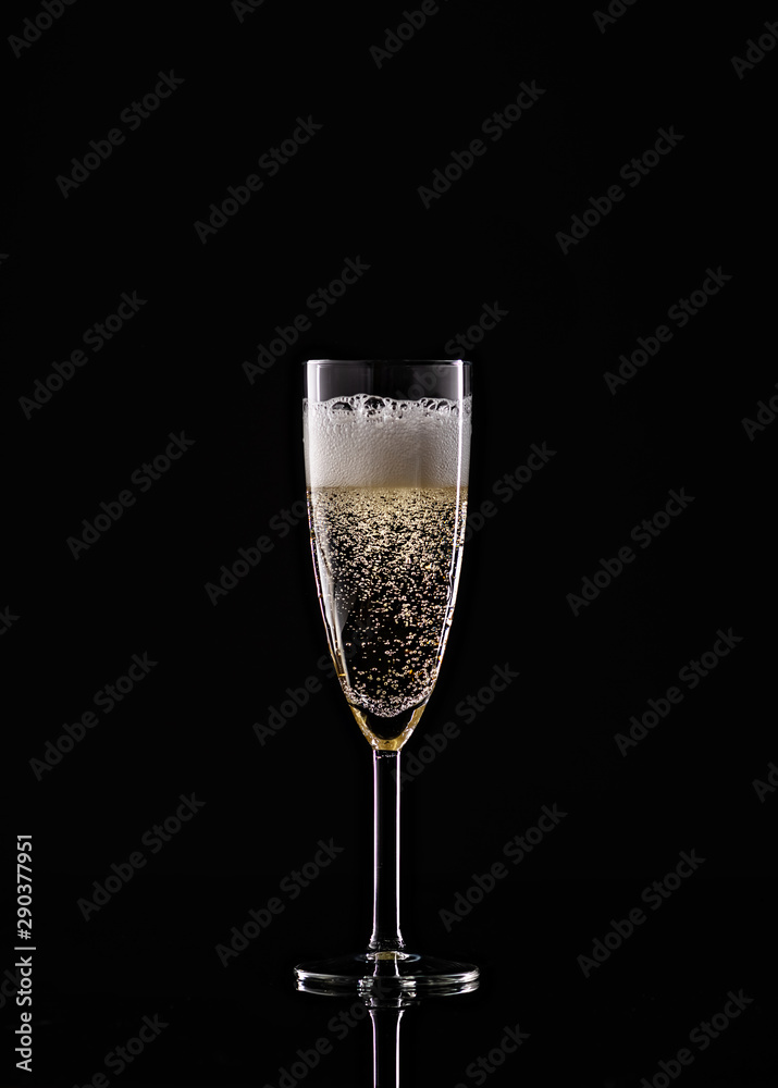 full champagne glass on black background