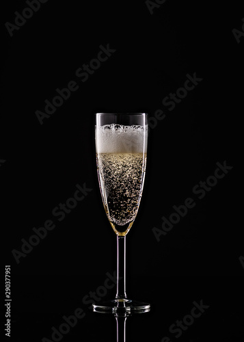 full champagne glass on black background