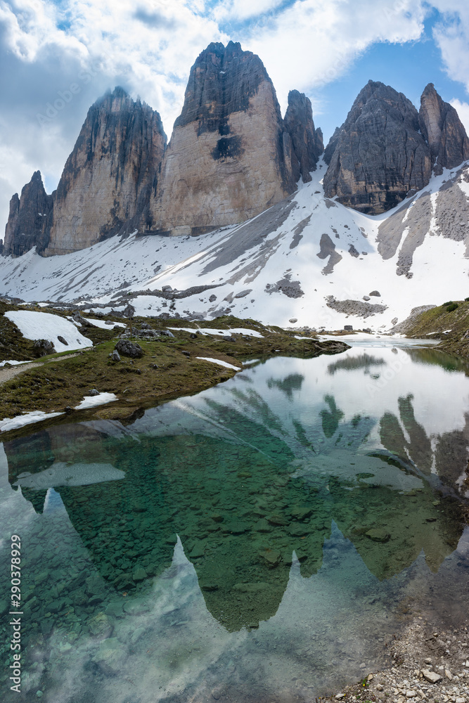 Beautiful view of Tre Cime di Lavaredo reflecting in the water. Dolomites, Italy