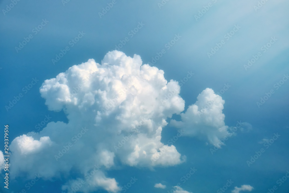 View on blue sky from airplane with big cloud. Large azure sunrise clouds shined from above, background. View on blue sky from airplane with big cloud. Large azure sunrise clouds shined from above, background.