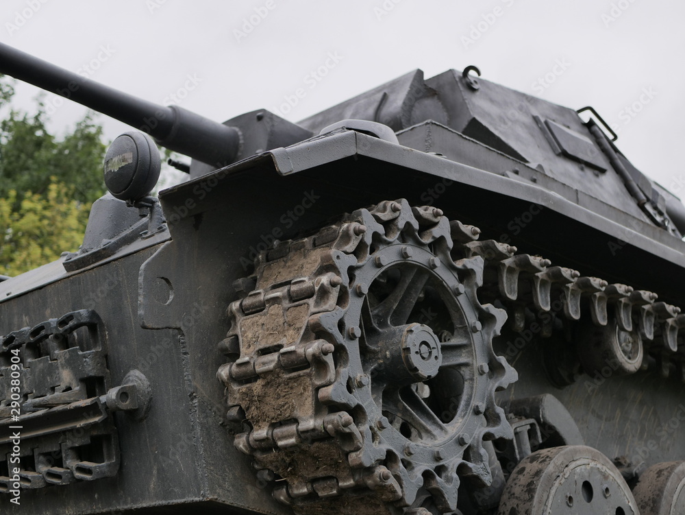 German medium tank of the Second World war in working order. the tank is painted black against a background of green trees in summer . German medium tank of the Second World war in working order. the tank is painted black against a background of green trees in summer .