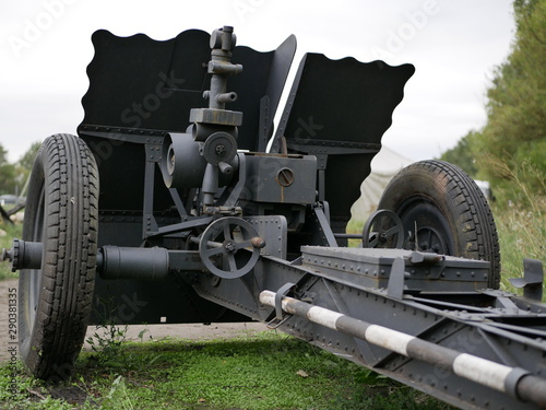 German cannon during the second world war on a cloudy summer day painted in black camouflage. photo