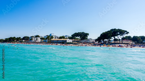 Tourists enjoying sun holidays on Alcudia beach, Mallorca