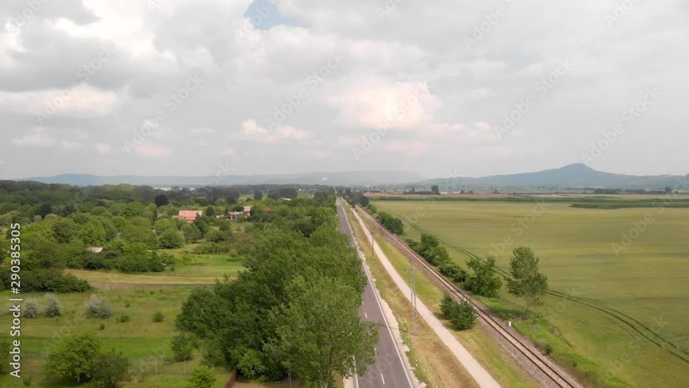 Aerial Rising Shot Over Two Lane Road Running Through Rural Farmland. Aerial Rising Shot Over Two Lane Road Running Through Rural Farmland.