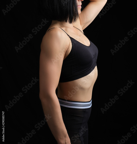body of a girl of athletic appearance in a black bra and leggings