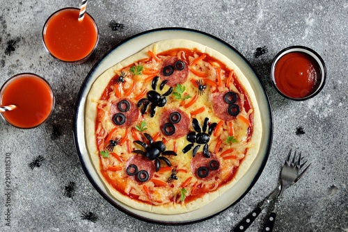 Cute pizza with olives and sausage spider for Halloween party. Children's food. 