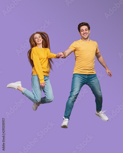 Happy couple jumping and holding hands © kegfire