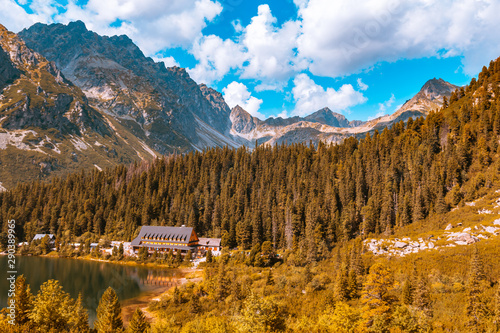 Beautiful autumn mountain landscape with a wooden house on the lake