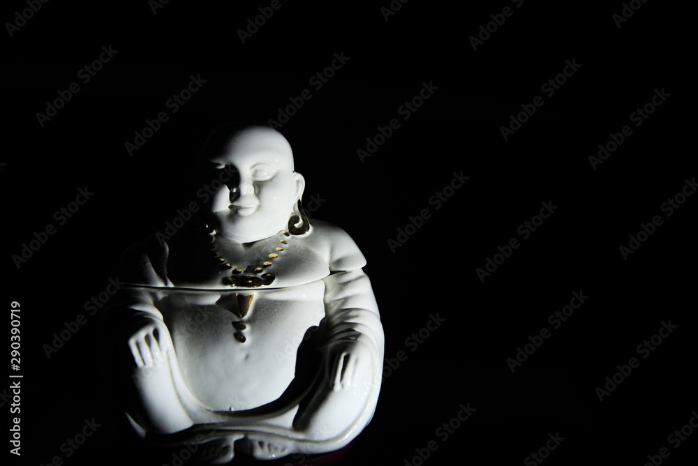 Buddha representation in the darkness, with copyspace Buddha representation in the darkness, with copyspace