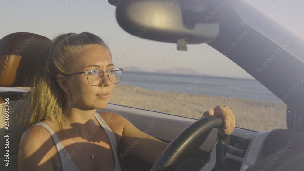 Naklejka premium Woman Driving Car By The Sea