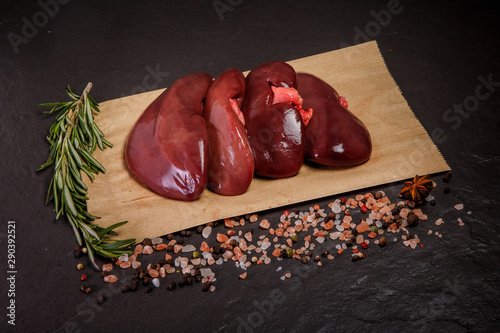 top view on group of raw pork kidneys with rosemary