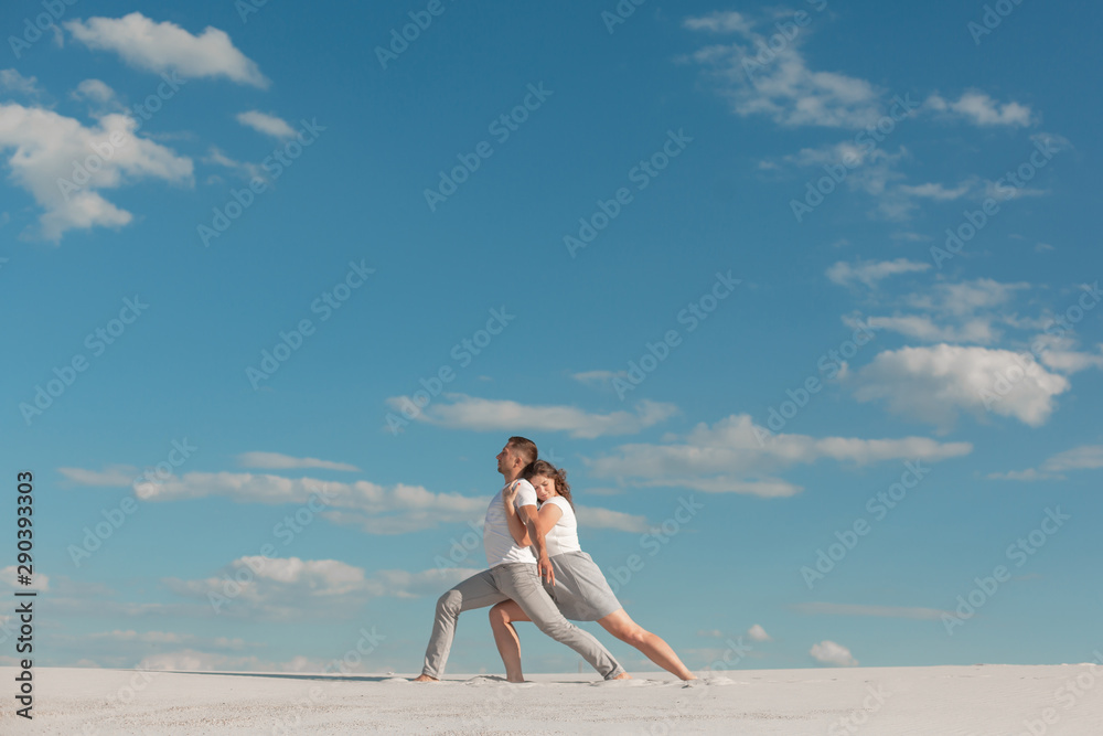 Romantic couple dancing in sand desert at blue sky background. Romantic couple dancing in sand desert at blue sky background.