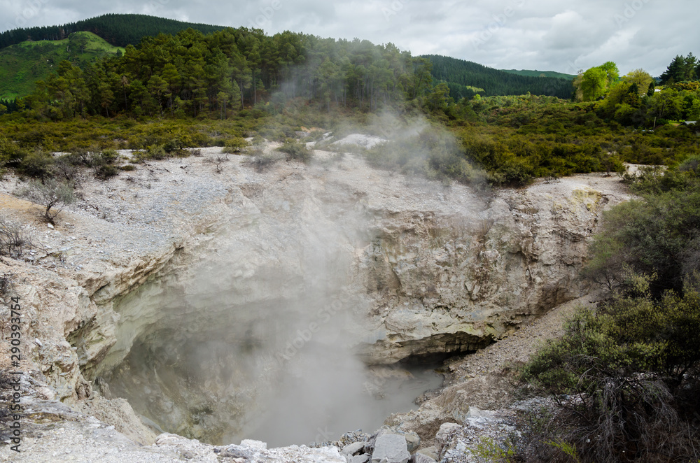 Hole in the ground of geothermal formation in natural park Hole in the ground of geothermal formation in natural park