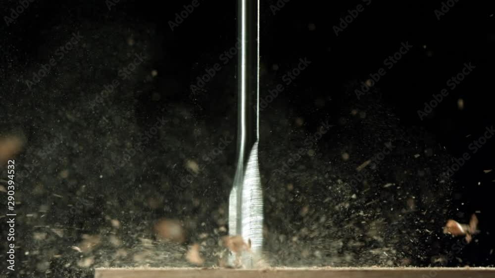 Slow motion close up, wood milling drill bit carves wood
