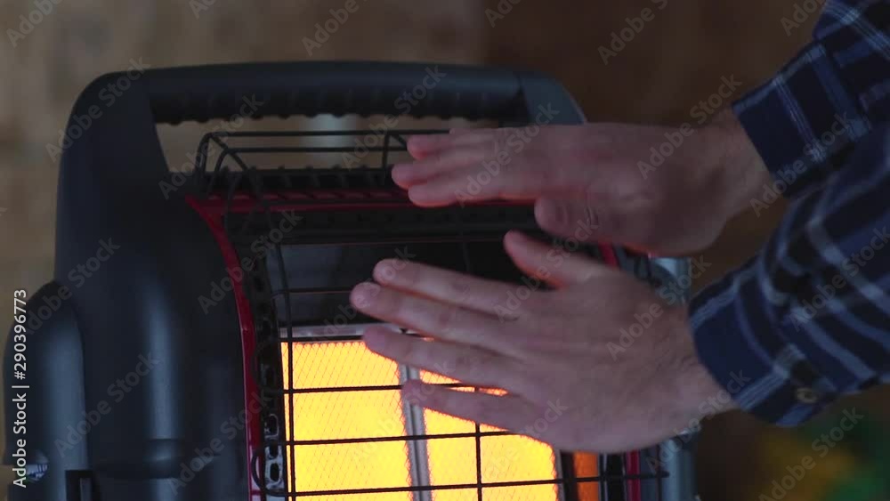 Hands warm near portable heater