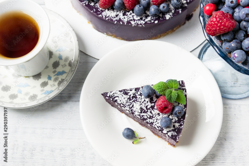 Vegan raw cake with raspberries and blueberries. Healthy vegan food concept. Sugar, dairy and gluten free dessert. Vegan raw cake with raspberries and blueberries. Healthy vegan food concept. Sugar, dairy and gluten free dessert.