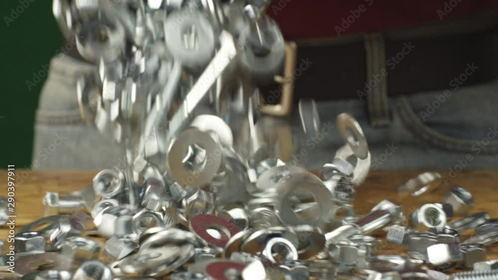 Slow motion, nuts and bolts hardware fall onto countertop Slow motion, nuts and bolts hardware fall onto countertop
