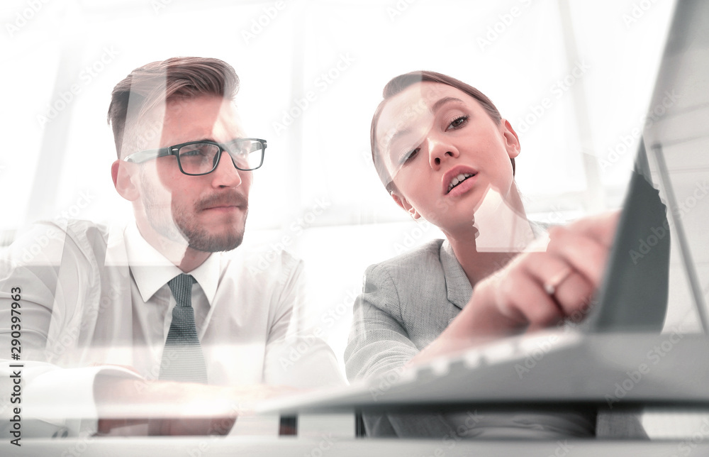 business couple discussing data on a laptop screen business couple discussing data on a laptop screen