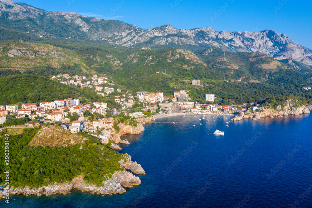 Aerial panoramic landscape of Budva Riviera, Montenegro. Scenic view of the coastline of Becici and Rafailovici on the Adriatic Sea on a summer day.