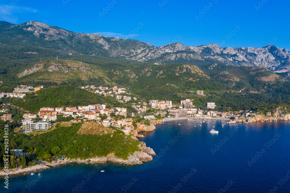 Aerial panoramic landscape of Budva Riviera, Montenegro. Scenic view of the coastline of Becici and Rafailovici on the Adriatic Sea on a summer day.
