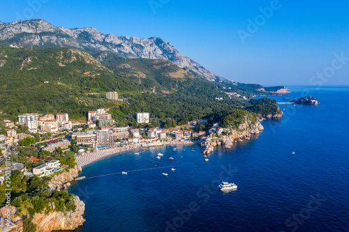 Fototapeta Naklejka Na Ścianę i Meble -  Aerial panoramic landscape of Budva Riviera, Montenegro. Scenic view of the coastline of Becici and Rafailovici on the Adriatic Sea on a summer day.