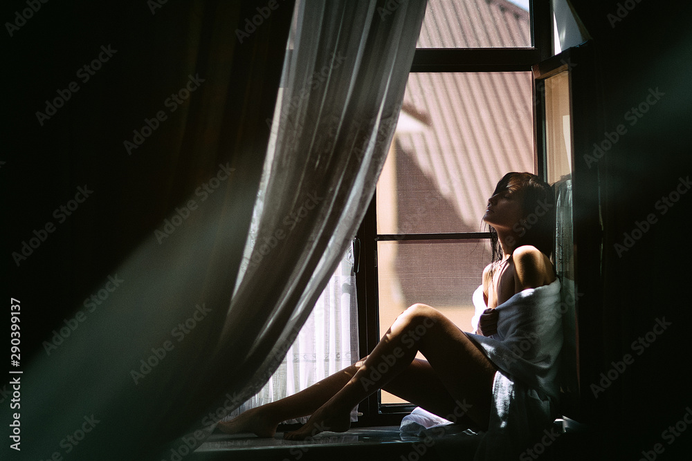 beautiful girl sitting by the window