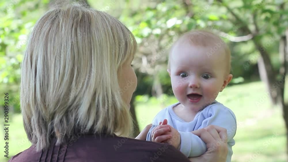Caucasian mother holding clapping baby Caucasian mother holding clapping baby