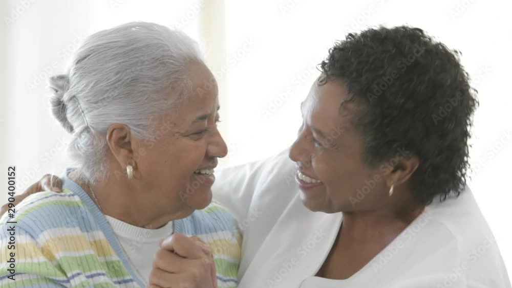 African American nurse smiling with senior patient African American nurse smiling with senior patient