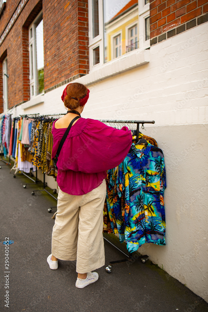 Fototapeta premium woman with shopping bags in street, Bornholm, Denmark