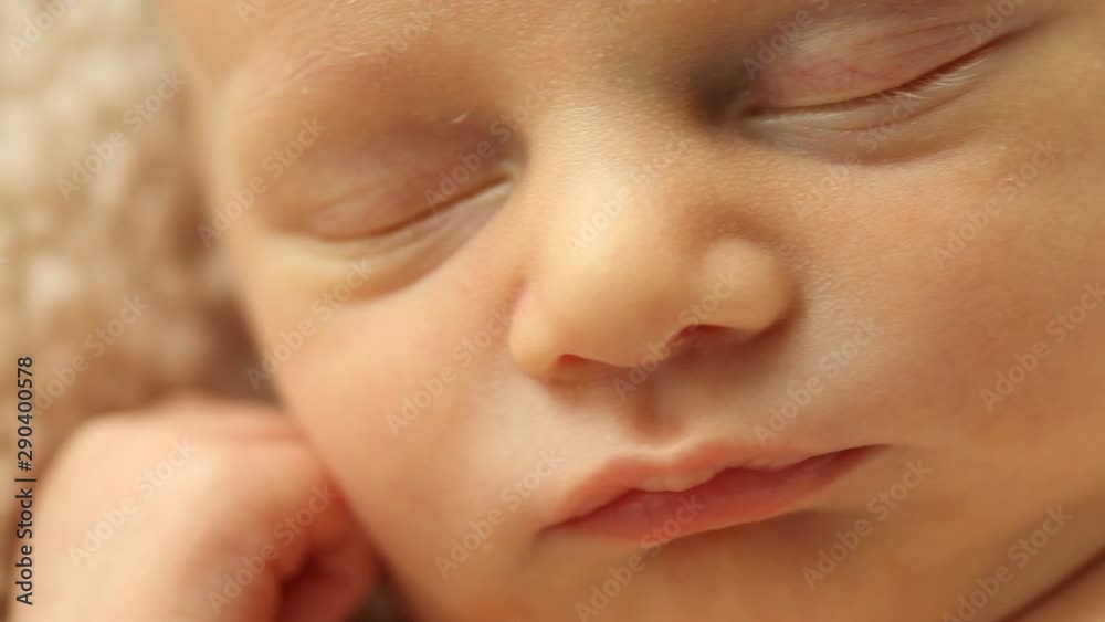 Fast track right to left over a sleeping Caucasian newborn's face Fast track right to left over a sleeping Caucasian newborn's face