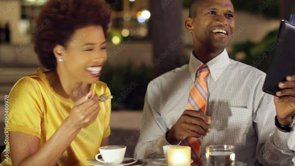 African American couple ordering from menu in cafe African American couple ordering from menu in cafe
