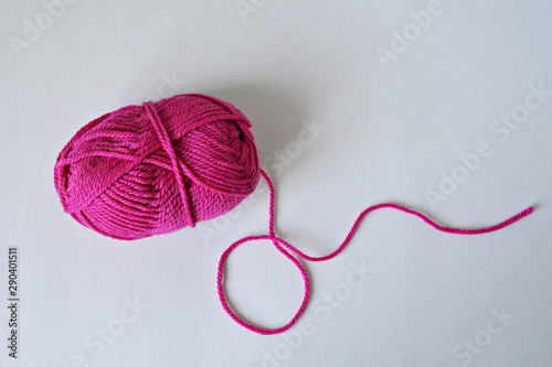 Hot pink knitting yarn ball over white