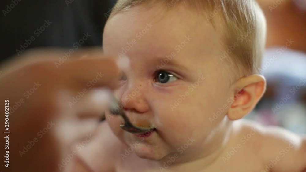 Caucasian baby boy being fed by mother Caucasian baby boy being fed by mother