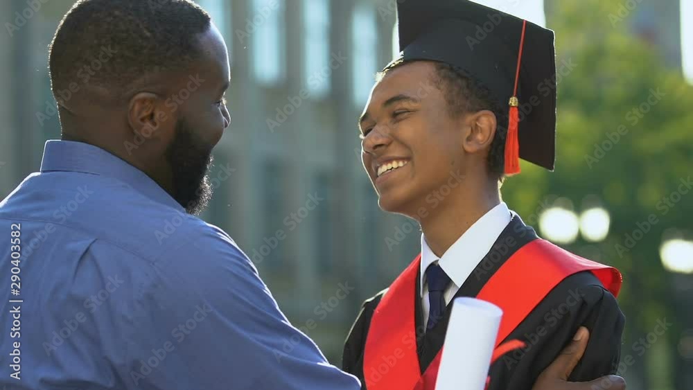 Happy Black Man Hugging Smiling Son In Magisterial Suit Proud Father Happy Black Man Hugging Smiling Son In Magisterial Suit Proud Father
