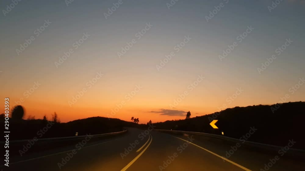 Driving on empty road at sunset Driving on empty road at sunset