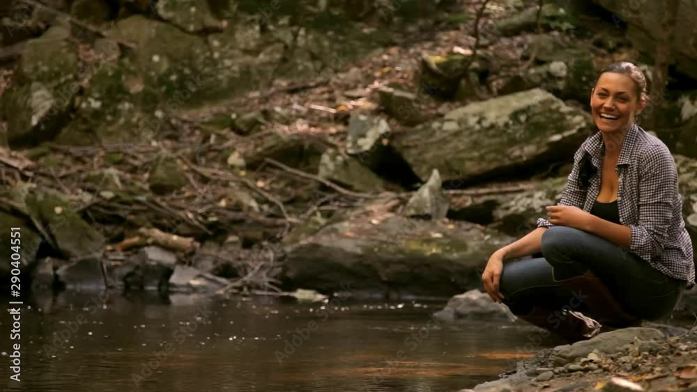 Caucasian woman throwing rocks in creek Caucasian woman throwing rocks in creek