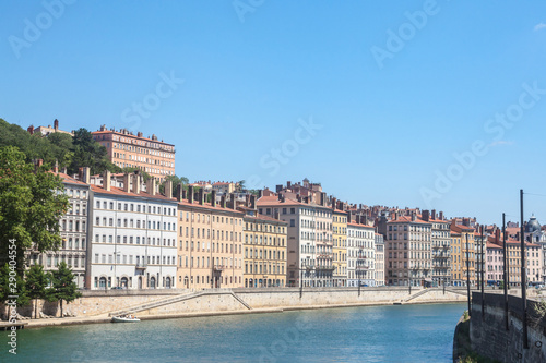 Panorama of Saone river and the Quais de Saone riverbank and riverside in the city center of Lyon, with a focus on the old building facades of the Presqu'Ile, also called Peninsula © Jerome