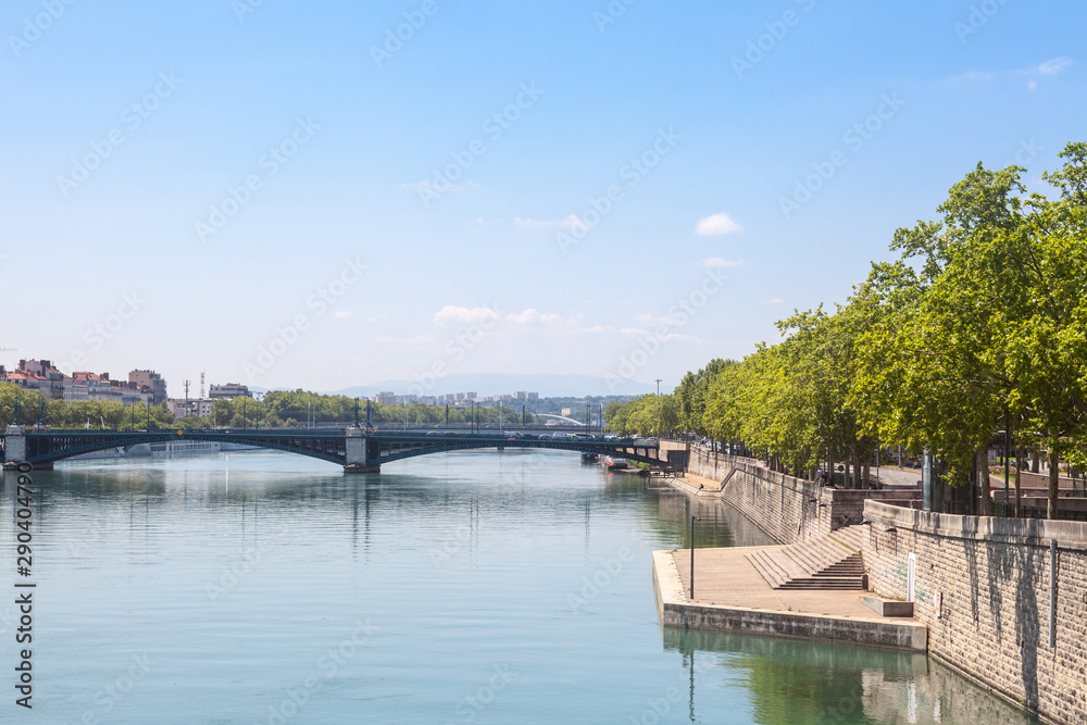 Pont de l'Universite bridge in Lyon, France over a panorama of the riverbank of the Rhone river (Quais de Rhone) with older buildings and the university building in background
