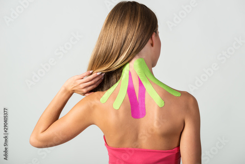 Kinesio tapes on the young woman's back