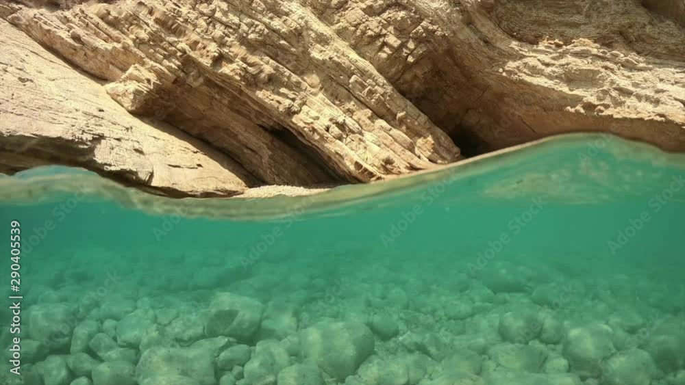 Underwater above and below video of tropical exotic paradise seascape with caves and crystal clear turquoise open ocean sea located in Caribbean popular destination Underwater above and below video of tropical exotic paradise seascape with caves and crystal clear turquoise open ocean sea located in Caribbean popular destination