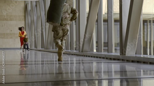 African American soldier greeting family in airport