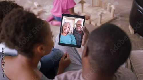 Family video chatting with grandparents