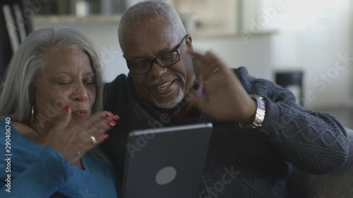 Black couple video chatting on digital tablet