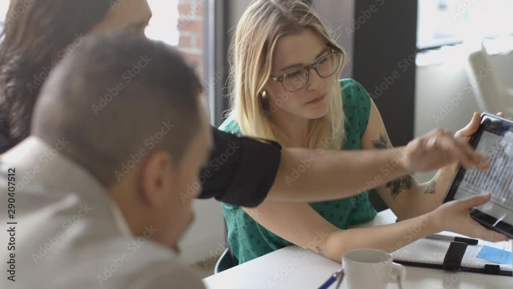 Creative millennial business people using digital tablet in meeting Creative millennial business people using digital tablet in meeting