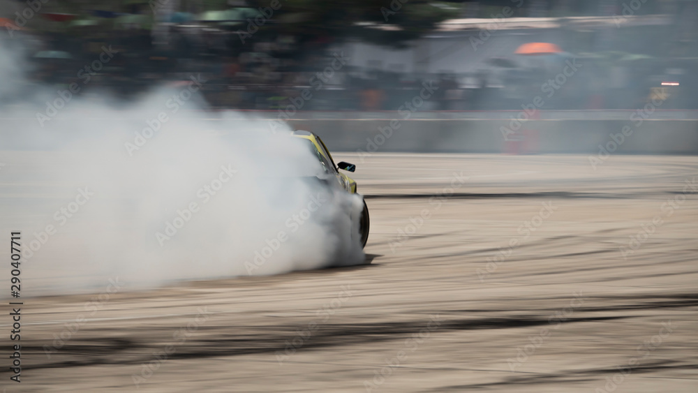 Car drifting, Blurred of image diffusion race drift car with lots of smoke  from burning tires on speed track Stock Photo