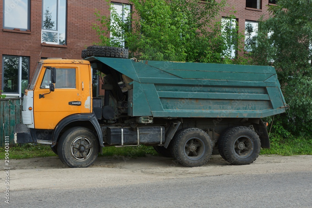 one big old color truck stands on the pavement on the road one big old color truck stands on the pavement on the road