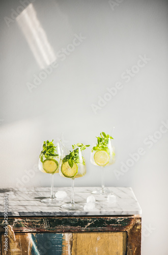 Hugo Sparkling wine cocktail with fresh mint and lime over white wooden and marble counter, white wall background, copy space. Cold refreshing summer alcoholic drink