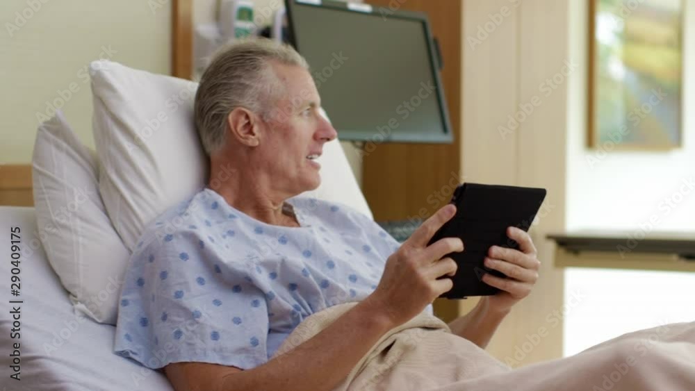 Nurses talking to patient in hospital bed with digital tablet Nurses talking to patient in hospital bed with digital tablet
