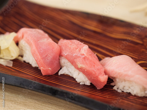 Set of three tuna sushi on a wooden plate photo